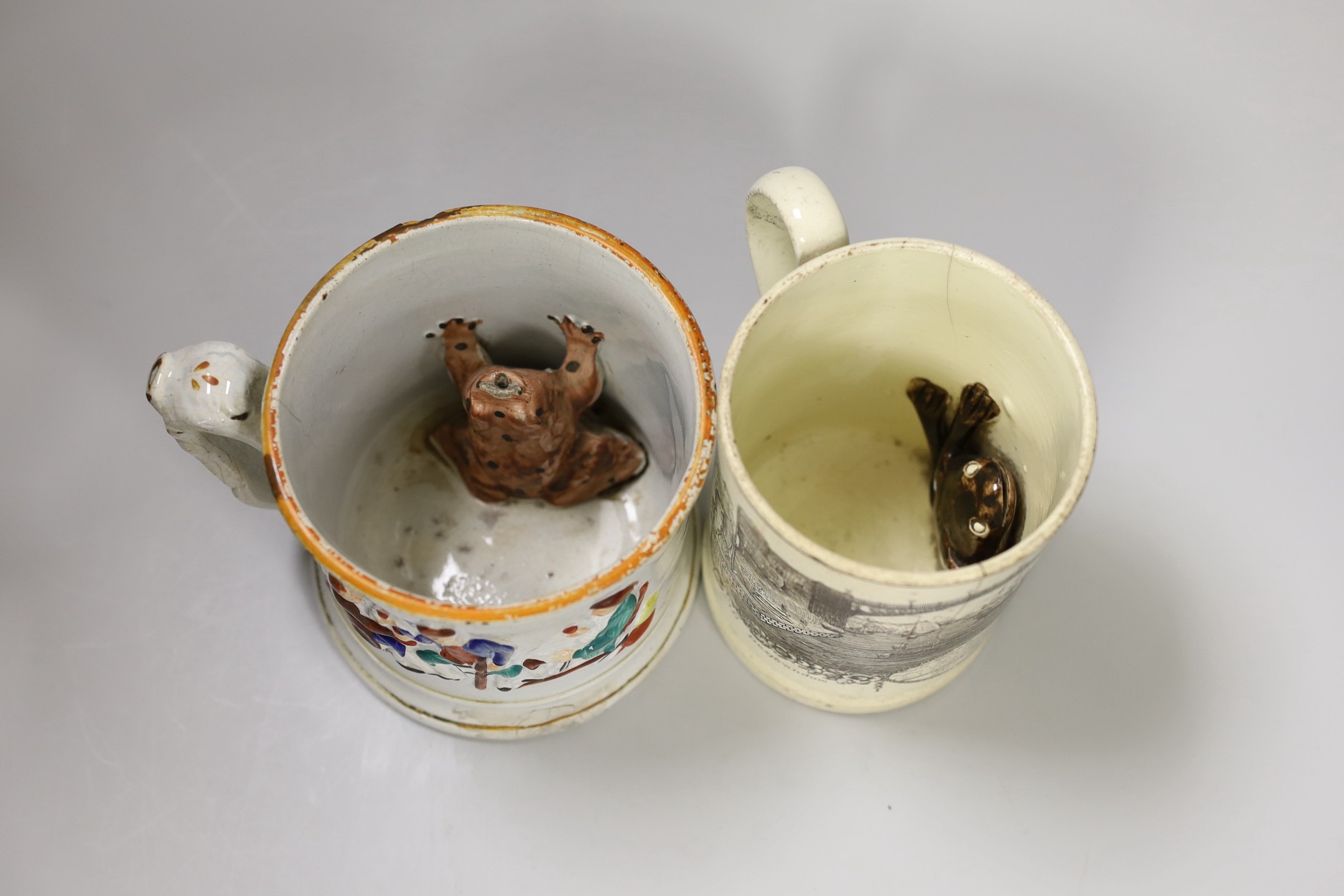 A Sunderland Bridge commemorative creamware ‘frog’ mug, c.1800, 13.5 cm high and a Staffordshire relief moulded mug